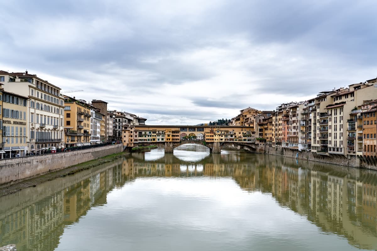The Ponte Vecchio over the Arno in Florence — the Vasari Corridor runs above its shops, linking the Uffizi to Palazzo Pitti